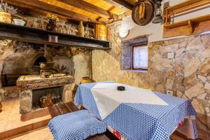 a kitchen with a table and a stone wall at Antique House Orlec in Orlec
