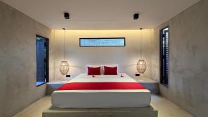 a bedroom with a large bed with red pillows at Three Tree Villa By Habarana in Habarana +119 photos