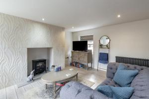 a living room with a couch and a fireplace at 1 Bed in Holt oc-1854 in Holt