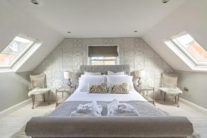 a bedroom with a large bed with two windows at 1 Bed in Holt oc-1854 in Holt