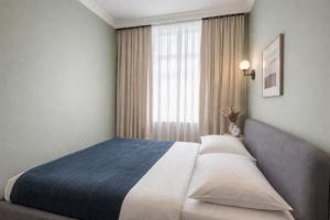 a bedroom with a bed and a window at City Heart Apartment in Tbilisi City