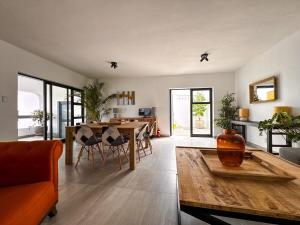 a living room with a table and a dining room at House Sworyx in Walvis Bay