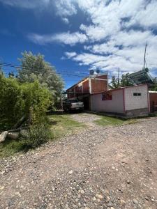 a building with a car parked in front of it at Dormis C la Familia in Malargüe