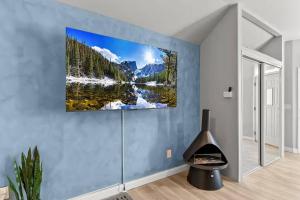 a room with a view of a lake in the mountains with snow at Boutique Studio Hideaway Near Forest Park in Saint Louis