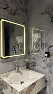 a bathroom with a sink and a mirror at Al Seef Hotel in Al-ʿUla +20 photos