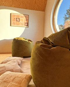 a room with two chairs and a large window at Lombtér in Pásztó