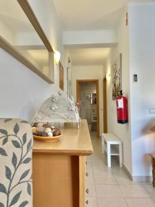 a kitchen with a bowl of fruit on a counter at Bayview Apartment 106 in Albufeira