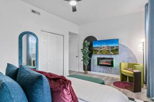 a living room with a couch and a fireplace at Abstract Haven | Stylish 1BR by Tower Grove in Saint Louis
