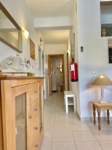 a bathroom with a sink and a red fire extinguisher at Bayview Apartment 106 in Albufeira