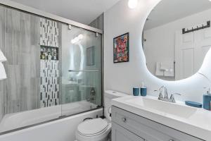 a bathroom with a sink toilet and a mirror at Abstract Haven | Stylish 1BR by Tower Grove in Saint Louis +27 photos