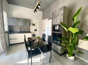 a kitchen and dining room with a table and chairs at Luxury Sofi in Giardini Naxos