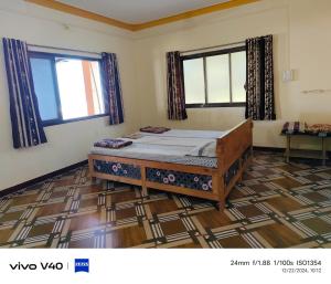 a bedroom with a bed in a room with windows at Silver sand beach resort in Malvan