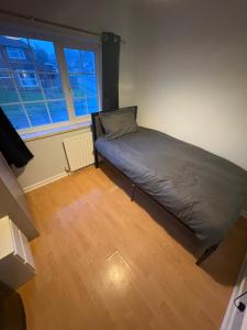 a bedroom with a bed in the corner of a room at Cosy room 6 T Gatwick in Crawley
