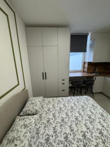 a bedroom with a bed and cabinets and a desk at 16 Airport Apartment in Vilnius