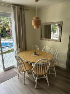 a dining room with a wooden table and chairs at The Barkly House Staycation in Biñan