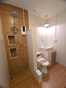 a bathroom with a shower and a toilet and a sink at Chortip House in Pai +44 photos