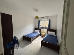 a small room with two beds and a window at The Barkly House Staycation in Biñan +32 photos