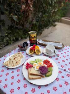 a table with plates of food and a cup of coffee at Carpe Diem Nungwi in Nungwi