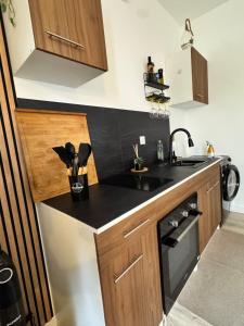 a small kitchen with a sink and a stove at Modern suite with jacuzzi in Toulon