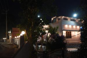 a white building with lights on it at night at pathayil villa in Thekkady