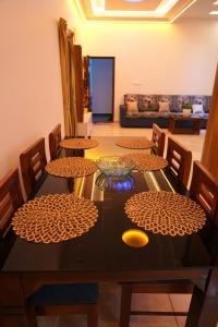 a dining room table with chairs and a bowl on it at pathayil villa in Thekkady