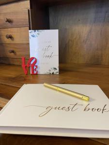 a pen on a piece of paper with a guest book at Once upon a time in Domaso
