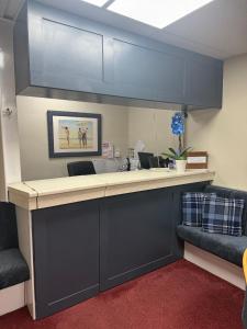 an office with a reception counter with blue cabinets at Silversands Hotel in Blackpool +11 photos