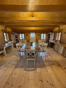 a large room with a wooden table and chairs at Izerski dom in Leśna