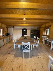 a dining room with a wooden table and chairs at Izerski dom in Leśna +80 photos