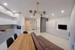 a large kitchen with a wooden table in a room at ApartPlus - Затишні апартаменти in Dnipro