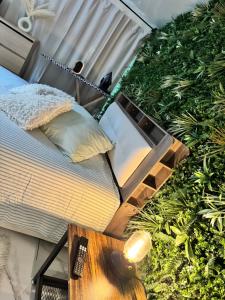 a bedroom with a bed and a table with a lamp at Modern suite with jacuzzi in Toulon