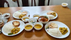 a table with plates of rice and different types of food at Pinepeak in Lava