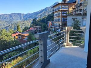a balcony with a view of a building and mountains at Pinepeak in Lava