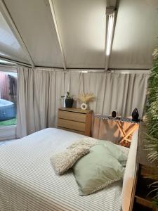 a bedroom with a bed in a tent at Modern suite with jacuzzi in Toulon