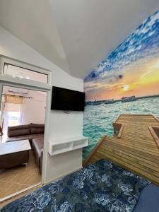 a living room with a couch and a view of the ocean at Apartman Sunce in Budva
