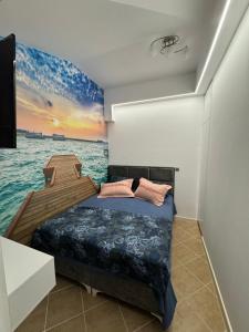 a bedroom with a bed and a boat in the water at Apartman Sunce in Budva