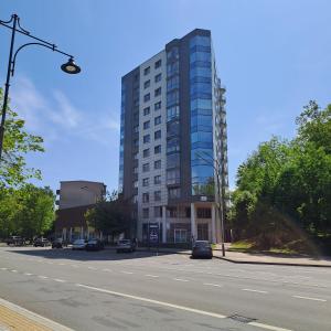a tall building on a city street with a road at Jacuzzi in Klaipėda