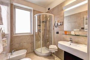 a bathroom with a shower and a sink at HOTEL HMR RHO Milano in Rho +33 photos