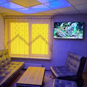 a room with a couch and a table and a window at Jacuzzi in Klaipėda +5 photos