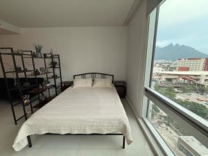 a bedroom with a bed and a large window at Apartment with pool on Paseo Santa Lucia in Monterrey +27 photos