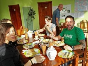 a group of people sitting around a wooden table at Ella Little Heaven guest in Ella