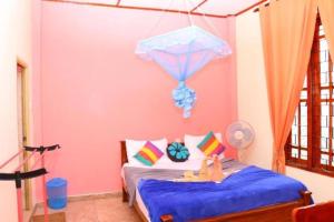 a childs bedroom with a bed with a blue blanket at Ella Little Heaven guest in Ella