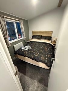 a bedroom with a bed and a window at The Ellerton at Eyemouth in Eyemouth