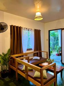 a room with two beds and a window at Paians 2BR Home, across Cloud 9, General Luna in Catangnan