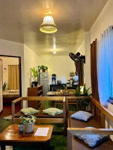 a living room with several tables and a chandelier at Paians 2BR Home, across Cloud 9, General Luna in Catangnan
