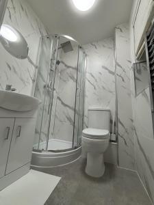a bathroom with a shower and a toilet and a sink at Haven at Chafford Hundred in West Thurrock +5 photos