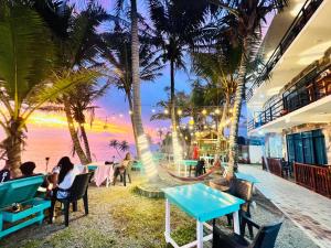 a restaurant with palm trees and a view of the ocean at Perfect view mirissa in Mirissa