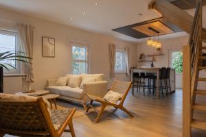 a living room with a couch and a table at Escapade Boisée in Vencimont +26 photos