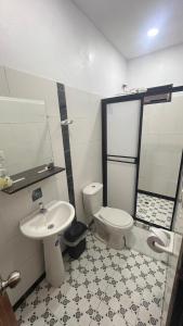 a bathroom with a toilet and a sink at Balcones de la Casona in Guatapé +111 photos