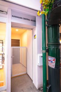 an entrance to a building with a green pole at Kawasaki Central House in Kawasaki